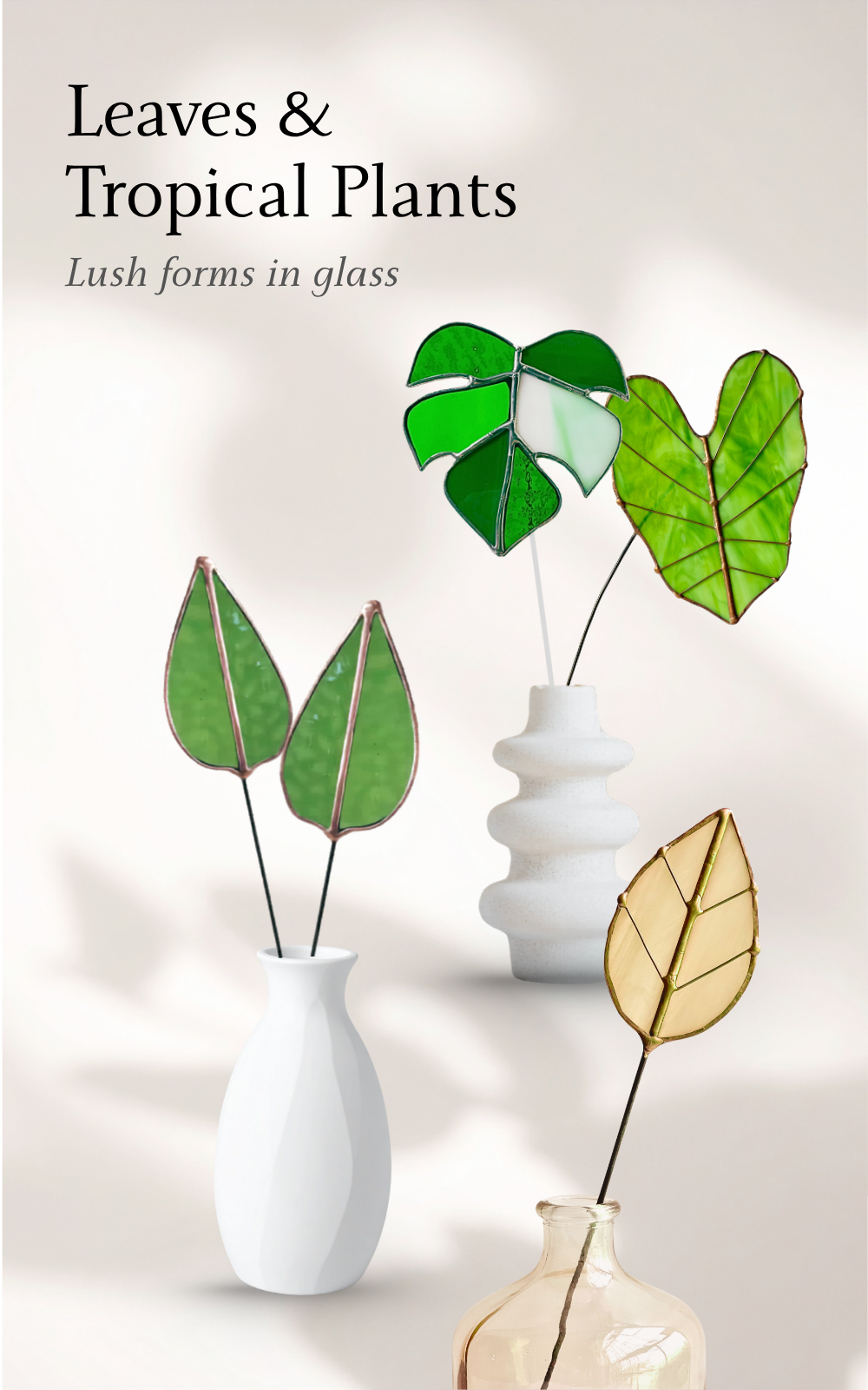 Stained glass tropical leaf designs including monstera and botanical stems displayed in modern vases with soft natural light