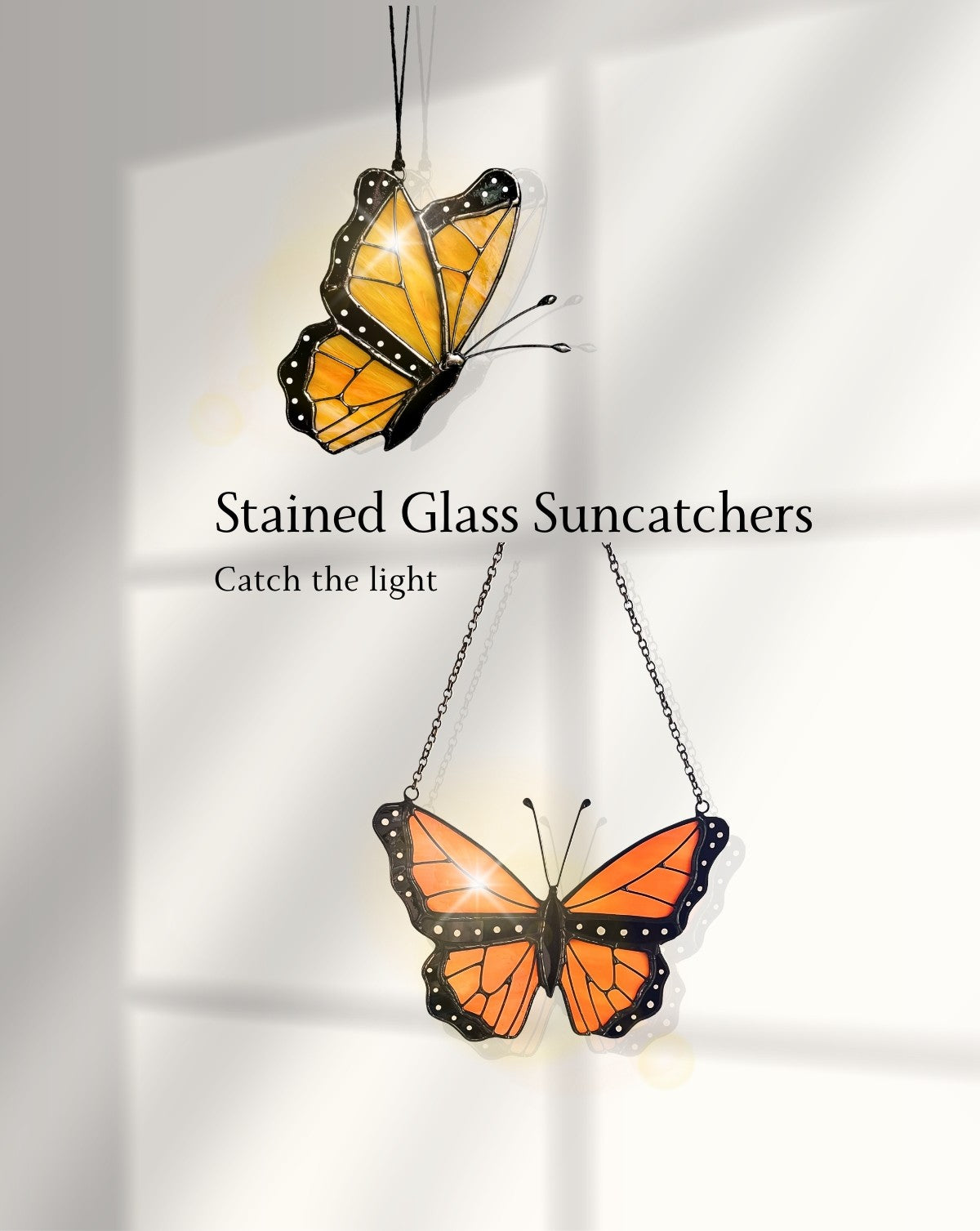 Stained glass butterfly suncatchers glowing in soft sunlight, casting warm light in a bright window