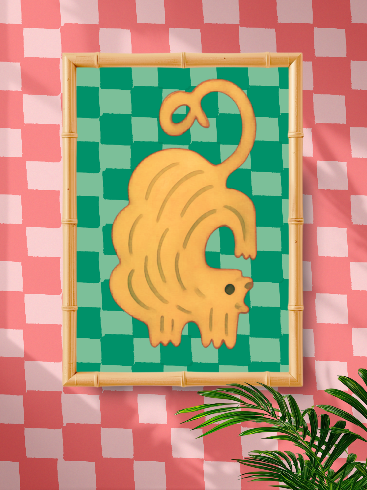 Framed artwork of a yellow cat on a green checkered background against a pink and white checkered wall.