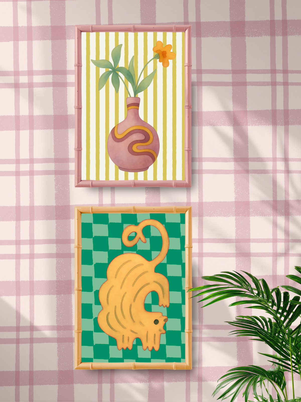 Two framed artworks on a wall with a pink plaid pattern