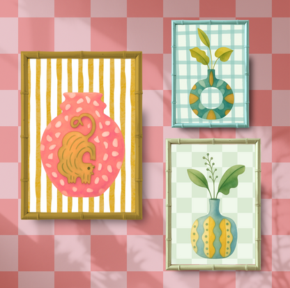 Three framed artworks on a pink checkered background
