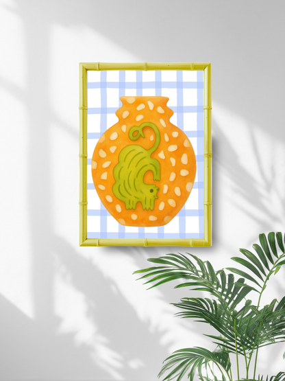 Decorative wall art with a yellow frame, orange polka dot vase, and ochre cat on a white background.