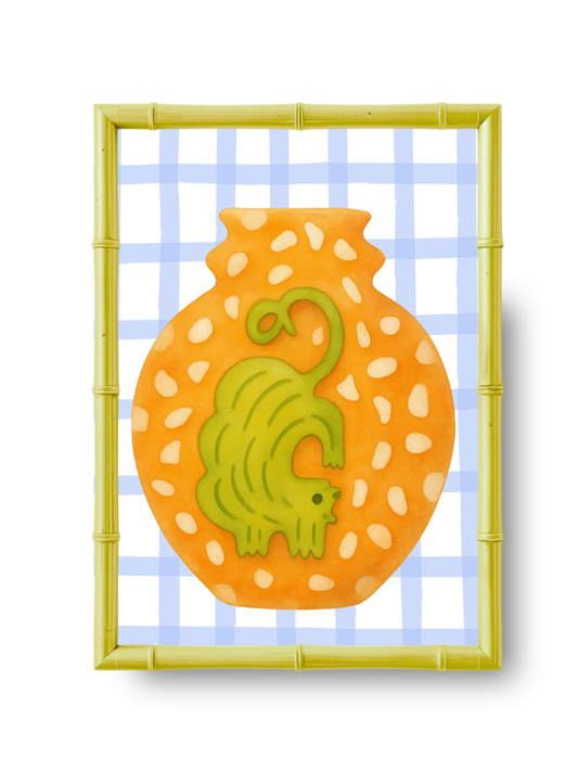 Decorative wall art with an ochre cat design on an orange background, framed by bamboo and against a blue checkered background.