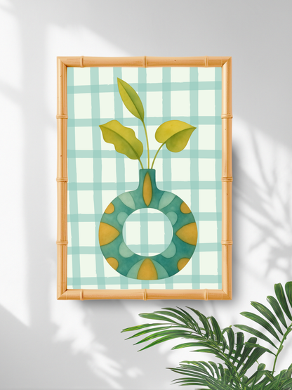 Decorative wall art with a green vase and leaves on a checkered background, framed in bamboo.