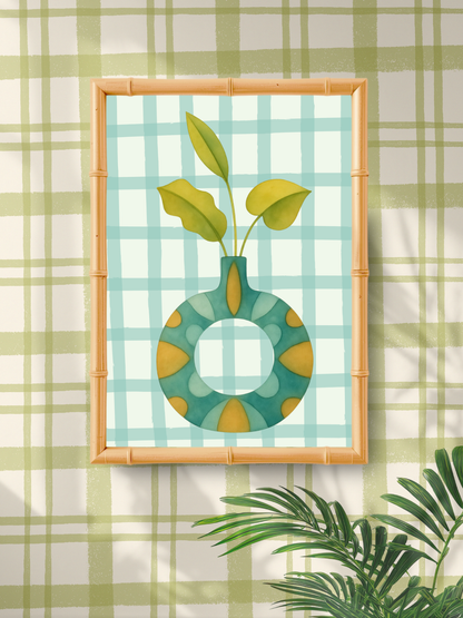 Framed artwork of a green vase with leaves on a plaid background
