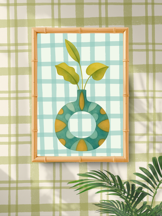 Framed artwork of a green vase with leaves on a plaid background