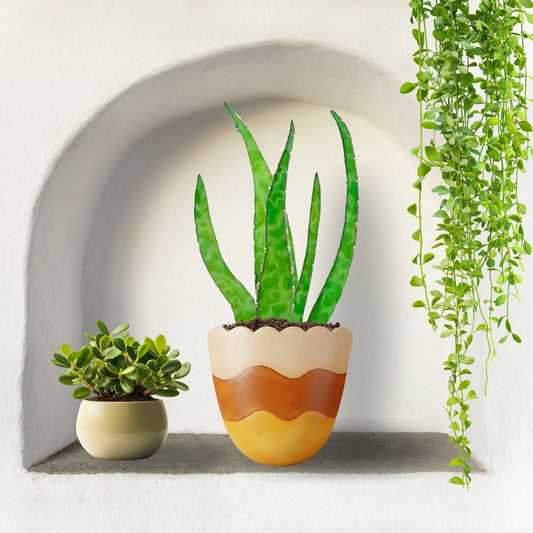 Stained glass aloe plant decor with green glass leaves in a decorative pot, styled in a wall niche with houseplants, modern botanical home decor.
