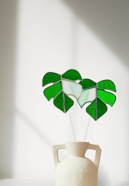 Stained glass leaf design in a white vase on a light background