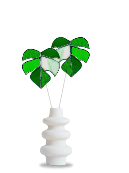 Decorative vase with green leaf-shaped design on a white background